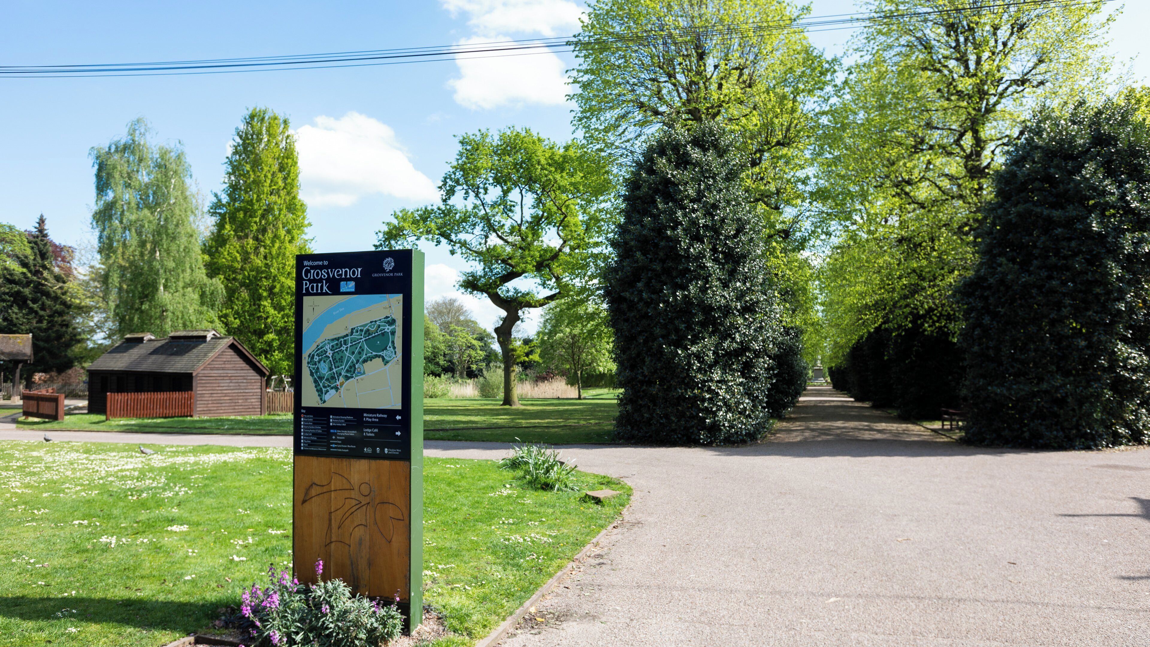 A park entrance sign with a map and directions.