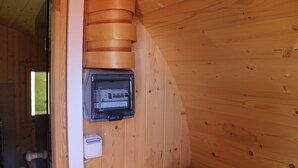 A wooden interior with a wall-mounted electrical panel and a thermostat. - Viola Tricolor, Exclusive FW on North Beach, pure relaxation, hiking, biking (Nordstrand)