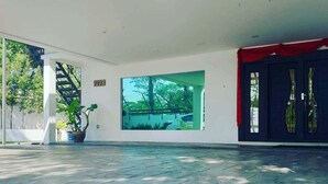 An indoor area with a large window, a staircase, and a potted plant. - Wawasan Homestay Butterworth (Butterworth)