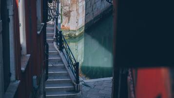 A narrow alleyway with a staircase leading down.