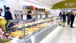 A bakery display with various pastries and a counter with a menu. - Casa Pacifico (Pompei)