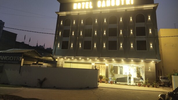 A hotel with a sign reading 'HOTEL SANOTRI' and a visible entrance with potted plants. - Hotel Gangotri (Haridwar)