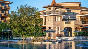 A hotel with a swimming pool, outdoor seating, and a large tree. - HVD Club Hotel Miramar - Ultra All Inclusive (Obzor)
