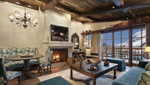 A cozy living room with a fireplace, comfortable seating, and a view of mountains through large windows. - Airelles Val d’Isère , Le Brussel's (Val-d'Isere)