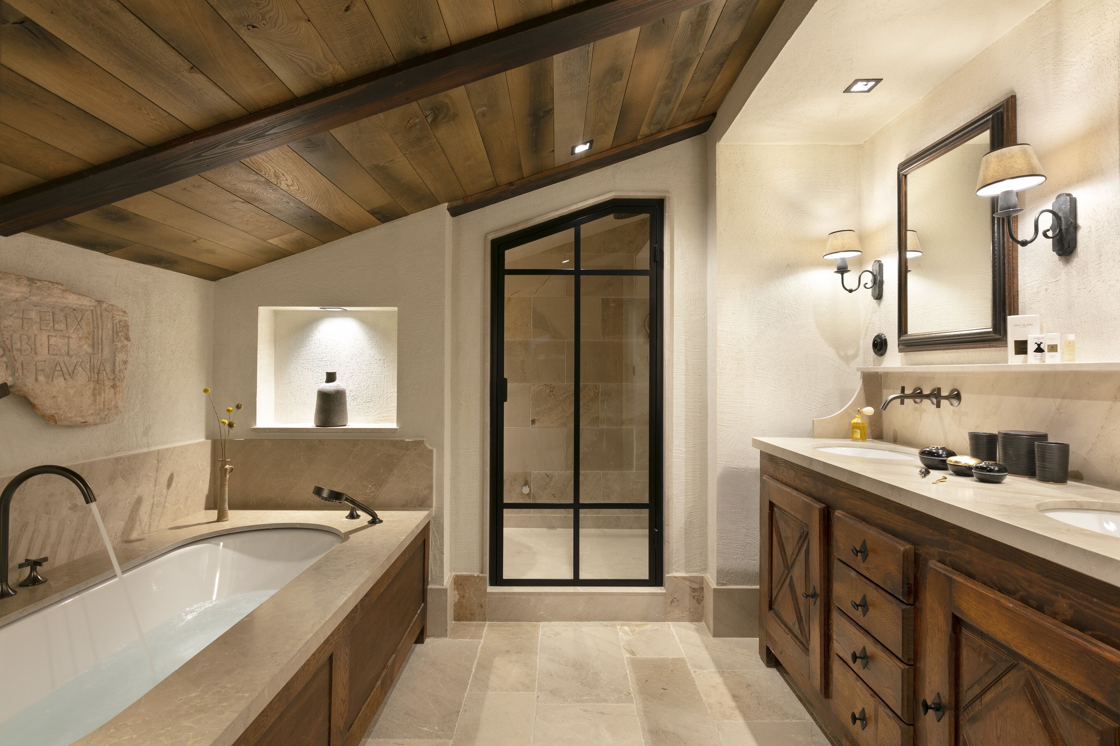 A modern bathroom with a freestanding bathtub, a walk-in shower, and a vanity with a large mirror.