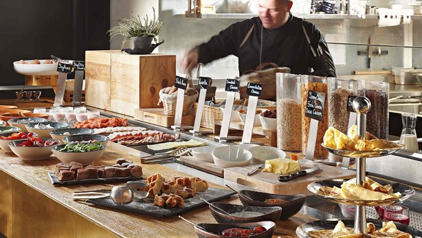 A buffet with various food items and labels indicating different types of cheese and spreads. - Mövenpick Zagreb (Zagreb)