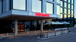A modern building with a prominent 'Mövenpick' sign, large windows, and a covered entrance area with outdoor seating. - Mövenpick Zagreb (Zagreb)