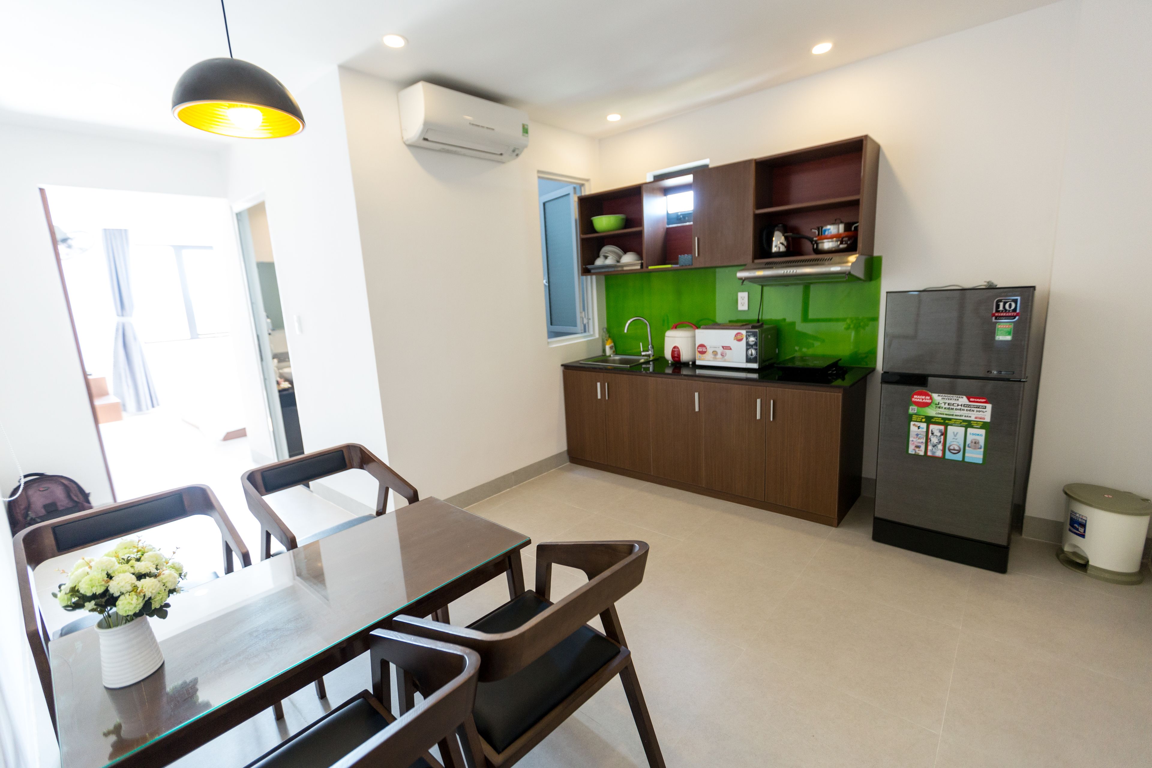 Fridge, electric kettle, cleaning supplies, paper towels