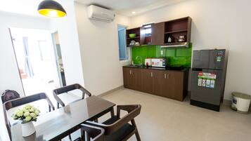 Fridge, electric kettle, cleaning supplies, paper towels
