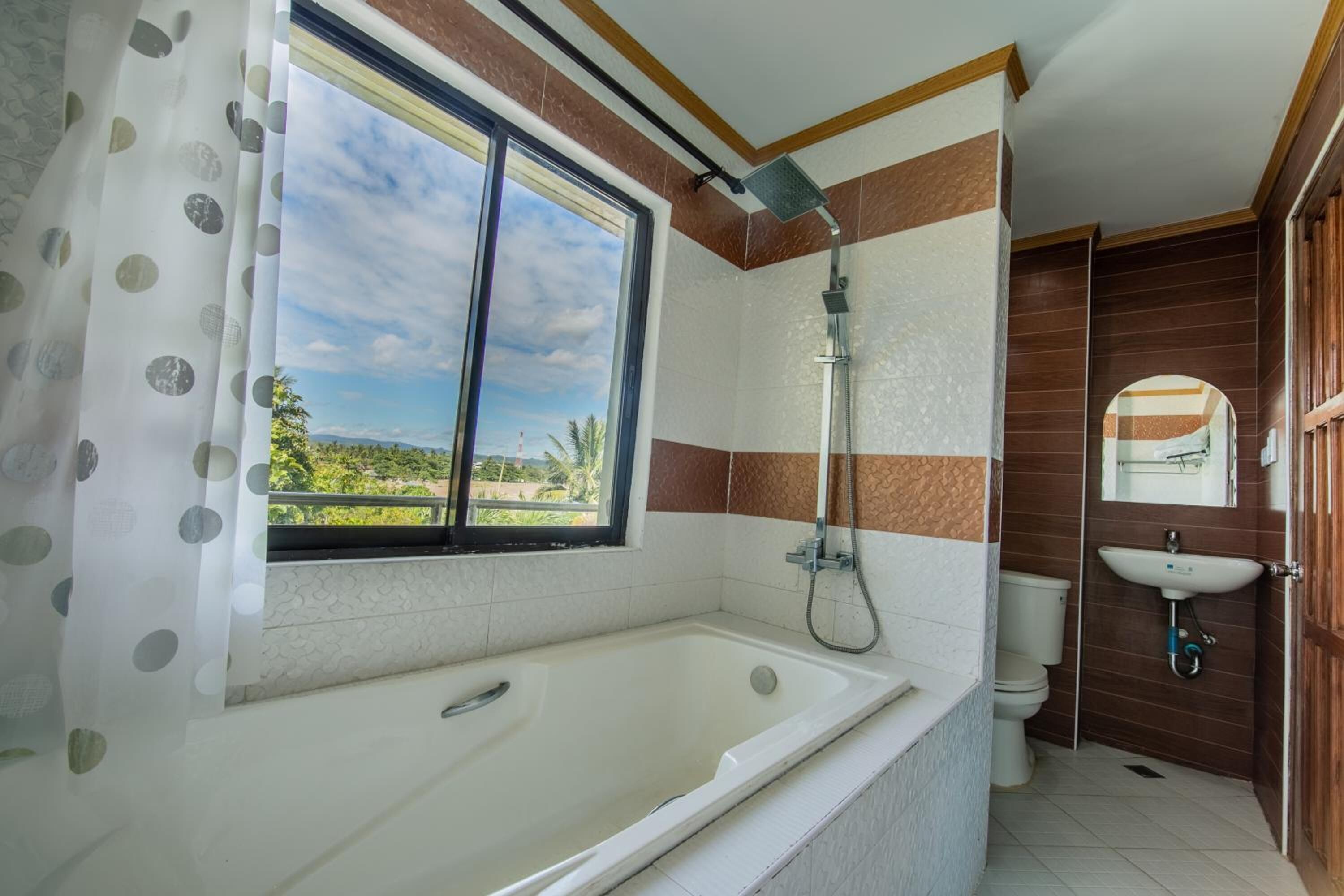 Ein Badezimmer mit Badewanne, Dusche, Toilette und Waschbecken.