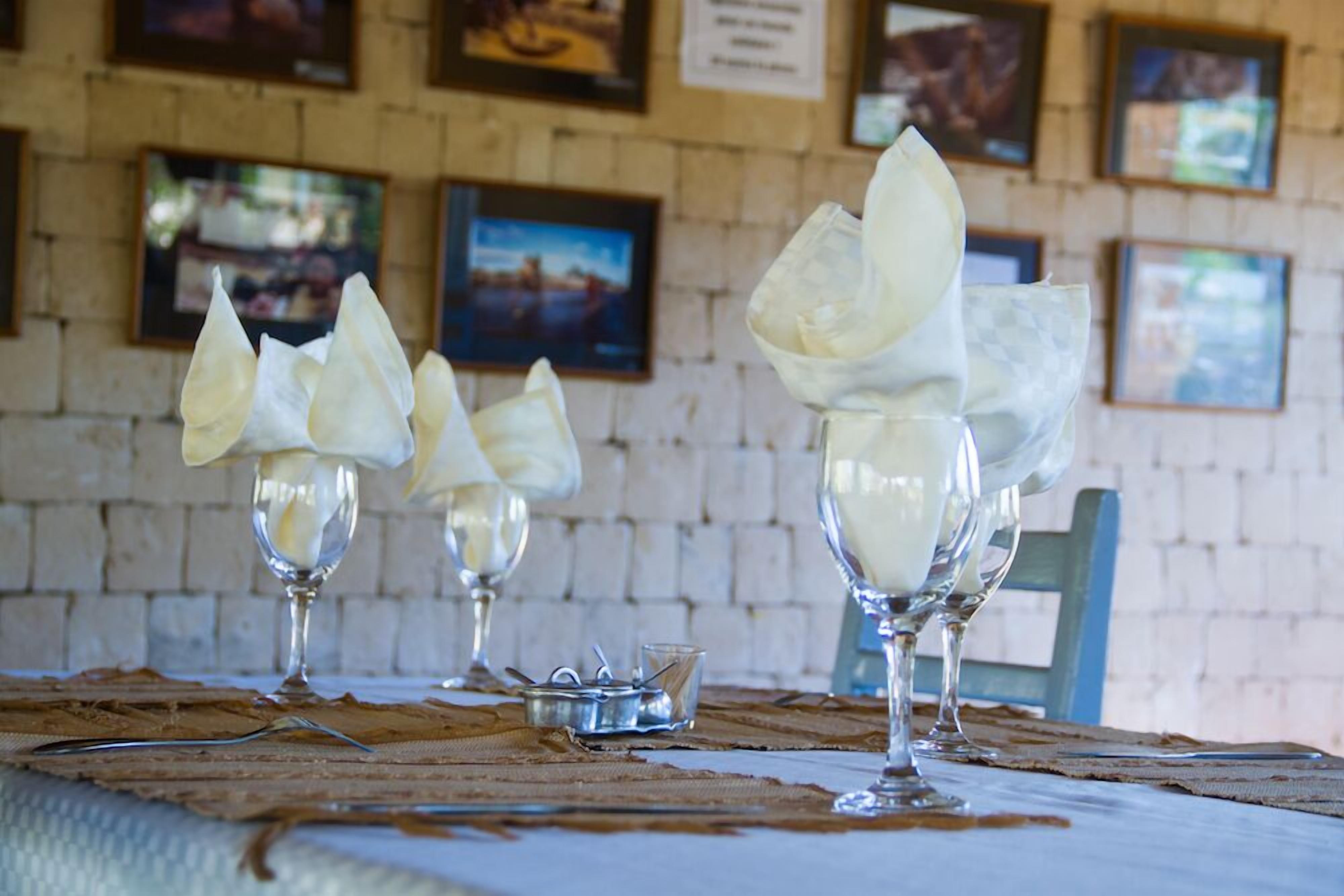 A table with three glasses of white dessert, possibly panna cotta, on a placemat.