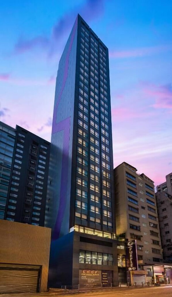 A tall, modern hotel building with a prominent vertical design element.