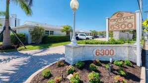 A residential area with a sign reading "Crystal Sands 6300" and a street lamp. - Crystal Sands Villa 12 - Private Beach (Sarasota)