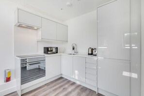 Departamento Premium, varias camas | Cocina privada | Refrigerador, microondas, horno y parrilla de estufa