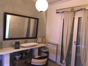 A bathroom with a large mirror, a sink, a towel rack, a radiator, and a shower curtain. - Luxury Apartment Sea View Garden Parking (Corfu)
