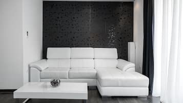 Suite Deluxe | Zona de estar | Una televisión de pantalla plana