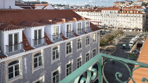 A multi-story building with a tiled facade and balconies.