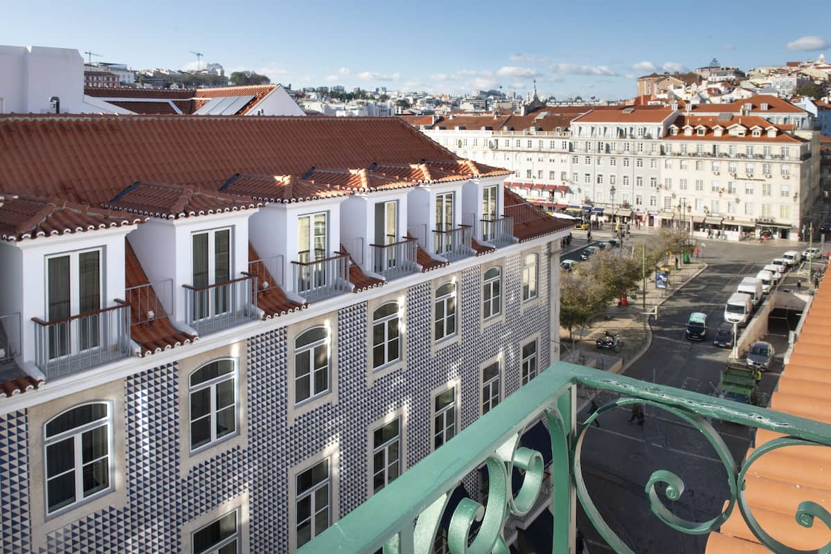 A multi-story building with a tiled facade and balconies.
