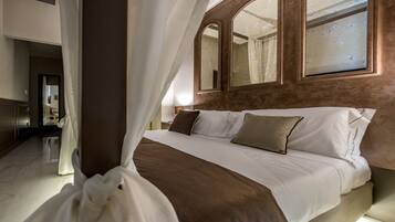 A modern hotel room with a large bed, a mirror, and a view of the hallway.