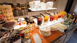 A buffet setup with various food items and condiments. - Hotel Restaurant & Spa - Le Cerf (Marlenheim)