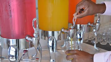 A hand squeezing a lemon into a glass.
