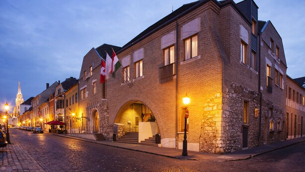 A historic building with a stone facade, large windows, and an arched entrance. - Hapimag Resort Budapest (Budapest)
