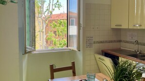 A kitchen with a window, a sink, and cabinets. - BNBOOK-BORROMEO 2 RHO (RHO)