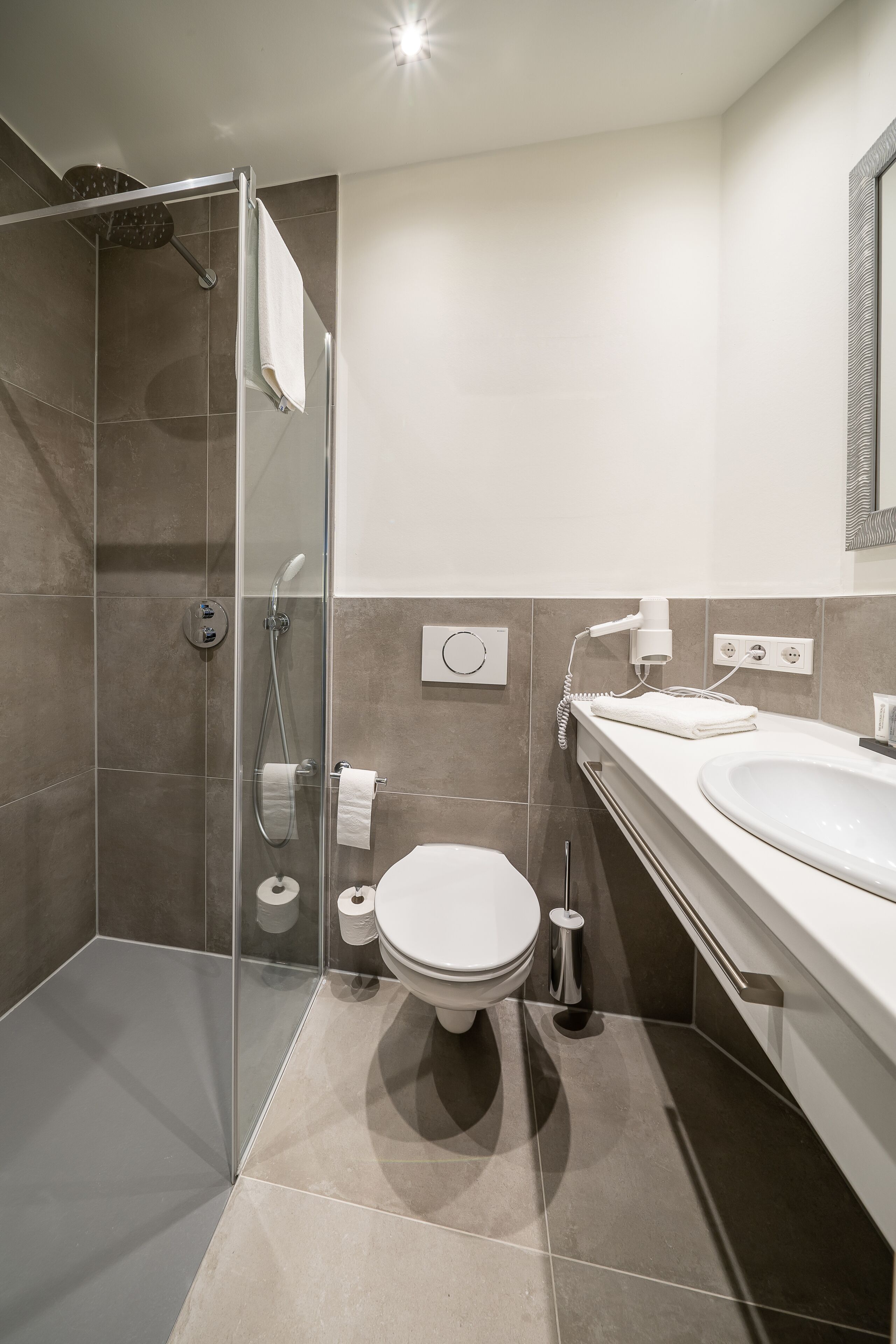 comfort single room | bathroom | hair dryer, towels, soap, shampoo