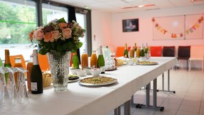 A long table set with various dishes, glasses, and bottles, likely for a meal or event. - Village Vacances La Fontaine d'Annibal (Buis-les-Baronnies)