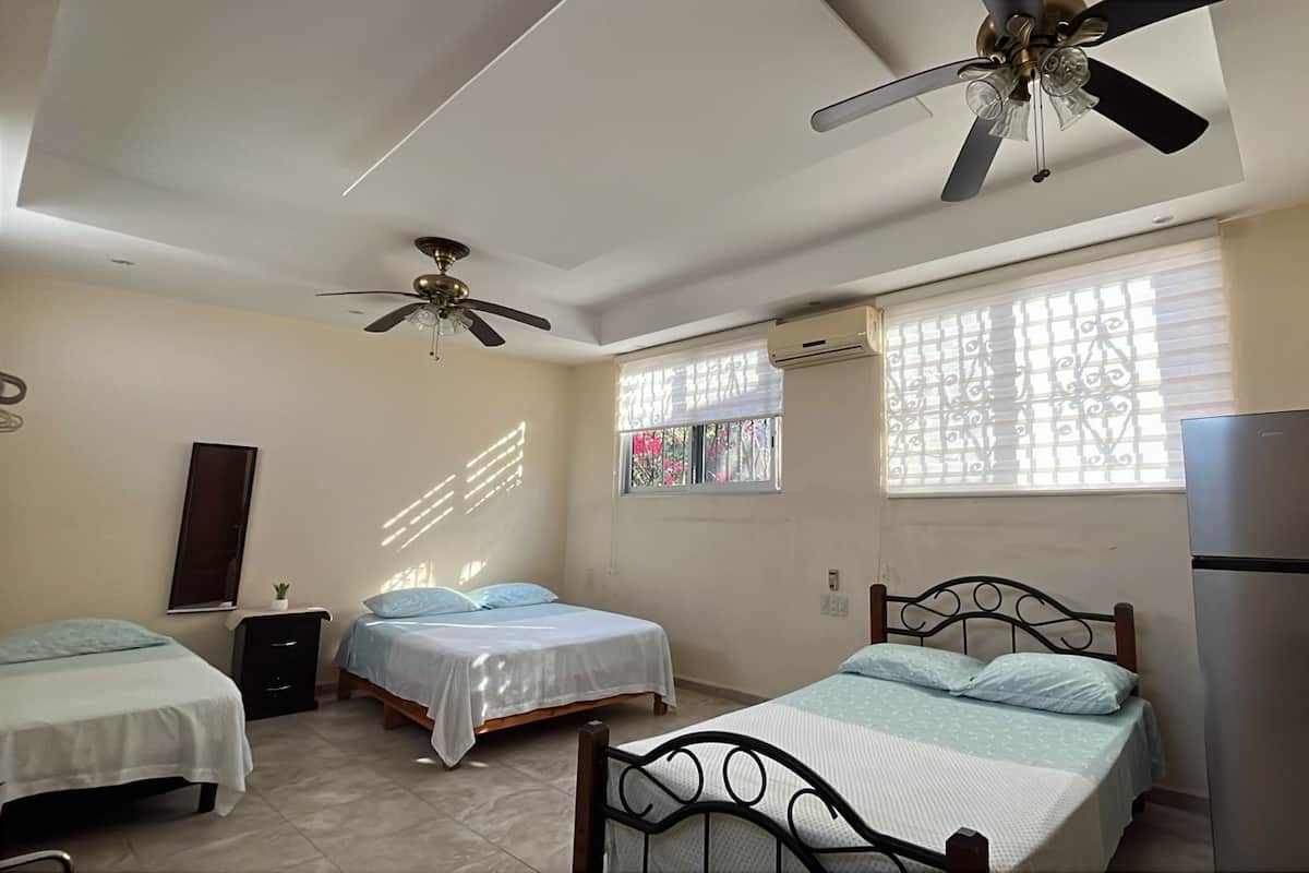 Family Room, Multiple Beds, Air conditioning, Garden View | Individually decorated, individually furnished, free WiFi, bed sheets