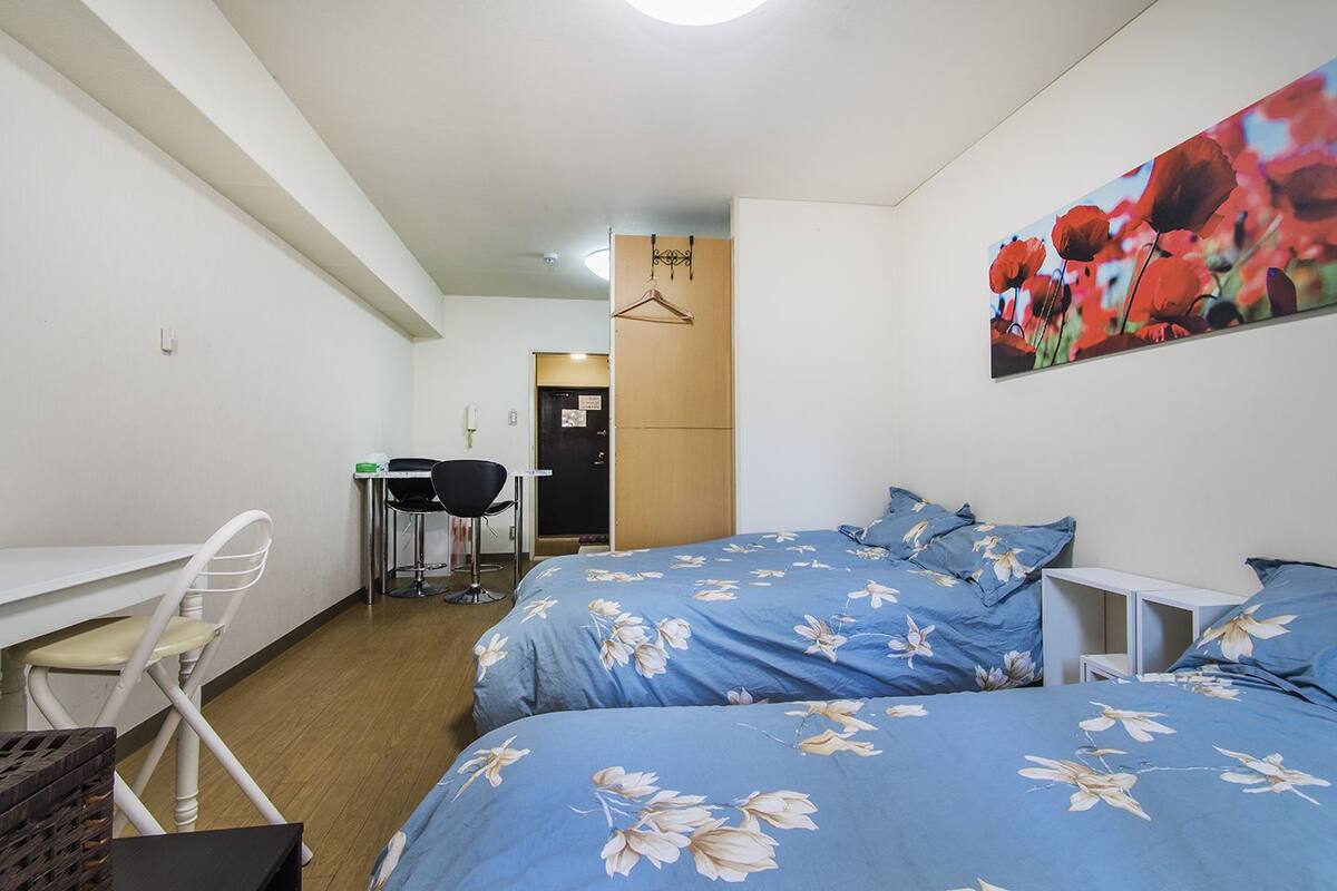 Ein Schlafzimmer mit Bett, Schreibtisch und Stuhl.