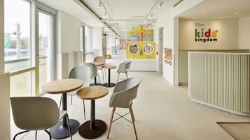 Experience a welcoming space designed for kids, featuring a central play area with a play structure and mirror.