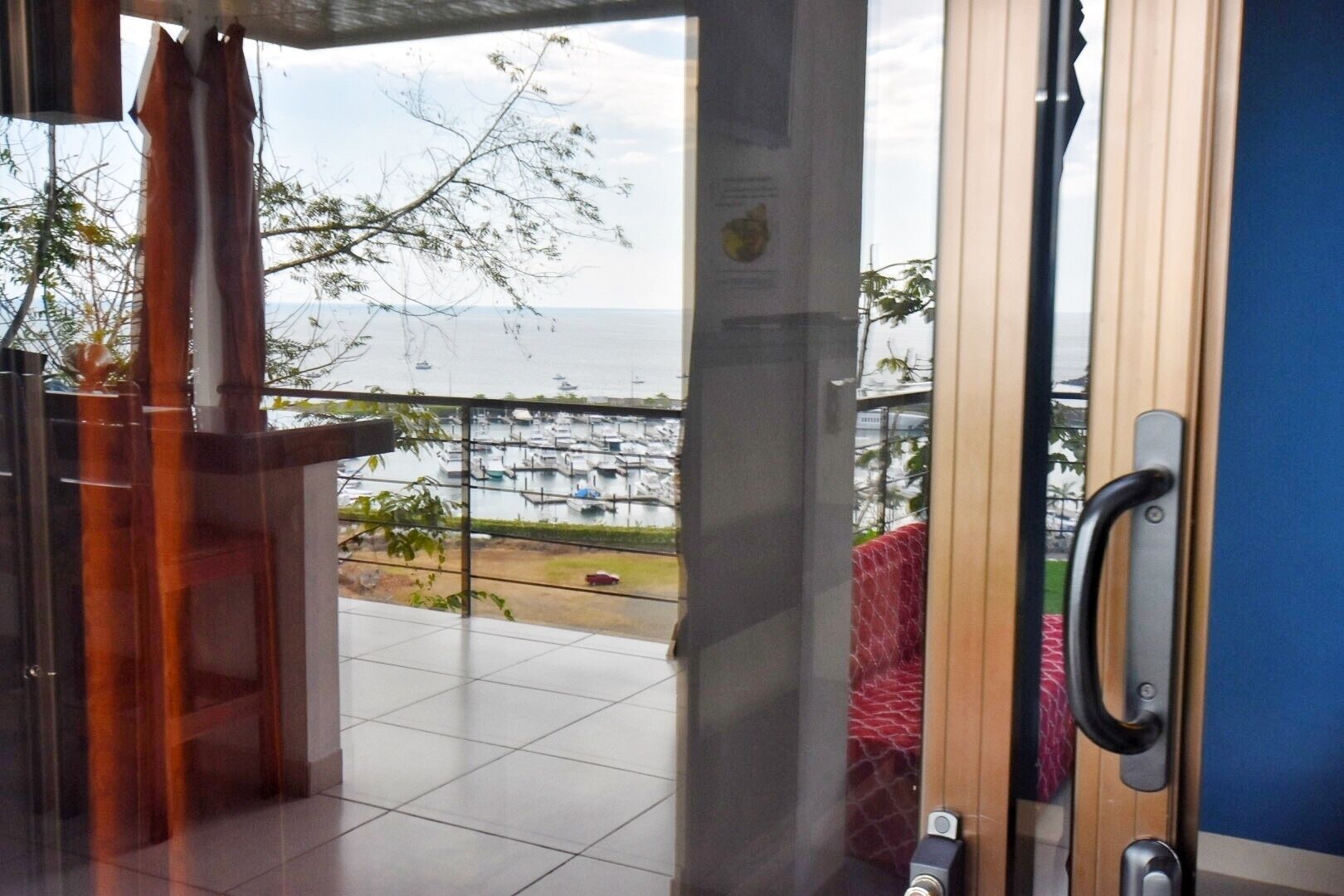A view from a balcony with a marina in the background.