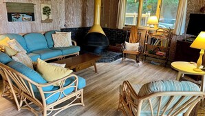 A cozy living room with a sofa, chairs, a fireplace, and a TV. -  Private Waterfront Setting on Lake Michigan (Shelby)