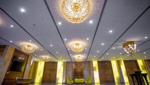 A spacious lobby with a central seating area, a reception desk, and a modern chandelier. - CITADEL Hotel By Vinnca (Hyderabad)