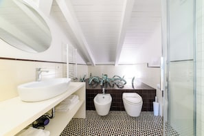 Deluxe Suite, Jetted Tub | Bathroom | Free toiletries, hair dryer, bidet