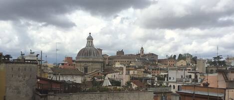 A cityscape with historic architecture, including a prominent dome and bell tower.