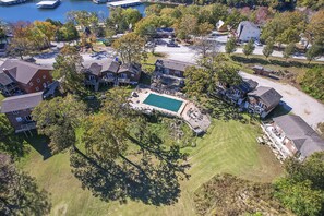 An aerial view of a residential area with a swimming pool, houses, and a dock. - White Wing Resort (Branson)