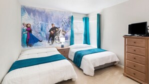 A bedroom with two beds, a dresser, a TV, and a mural on the wall. - Windsor Palms Resort 8017 (Kissimmee)
