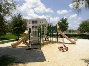 Explore the playground's multi-level structure with climbing walls and slides.