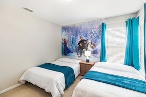 A bedroom with two beds, a nightstand, a wall mural, and a window with curtains.