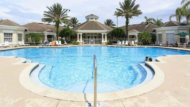 A swimming pool with lounge chairs and palm trees. - Windsor Palms Resort 2357 (Kissimmee)