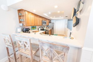Enjoy cooking in this well-equipped kitchen with a central island, sink, and microwave.