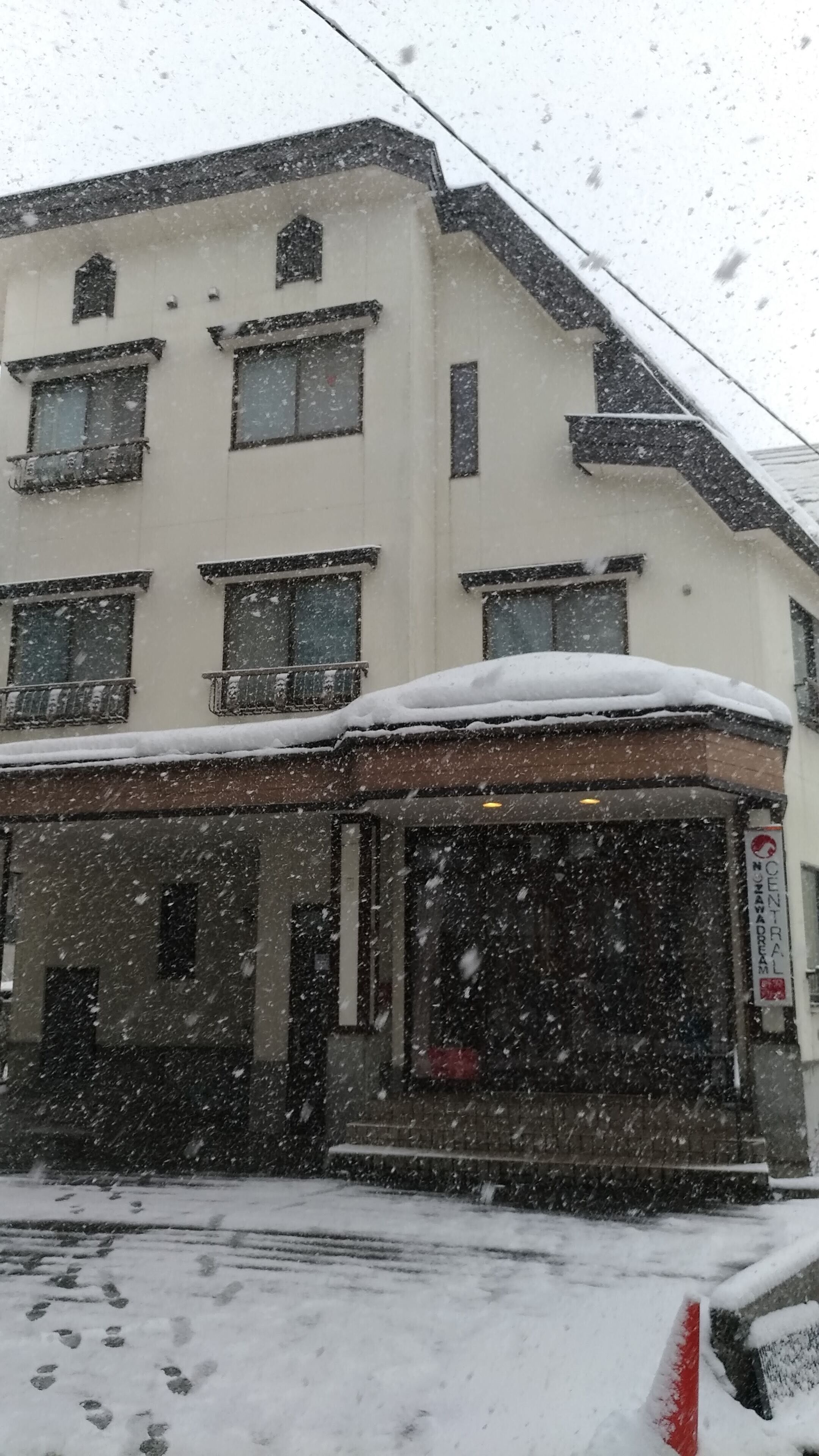 A building with multiple windows and a snow-covered roof.