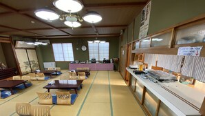 A traditional Japanese restaurant with tatami mats, wooden tables, and chairs.