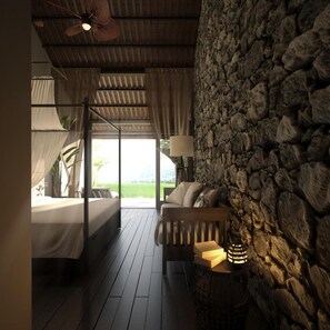 A bedroom with a bed, a sofa, a lamp, and a stone wall. - Aravinda Resort (Nam Hoa Lu)