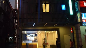 A hotel with a prominent 'HOTEL MM' sign, a glass entrance, and a visible reception area. - MM Hotel at Sunway (Petaling Jaya)