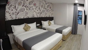 A hotel room with two beds, a large patterned wall, a window with curtains, and a flat-screen TV. - MM Hotel at Sunway (Petaling Jaya)
