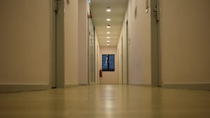 A long, narrow hallway with doors on both sides and a fire extinguisher mounted on the wall. - MM Hotel at Sunway (Petaling Jaya)