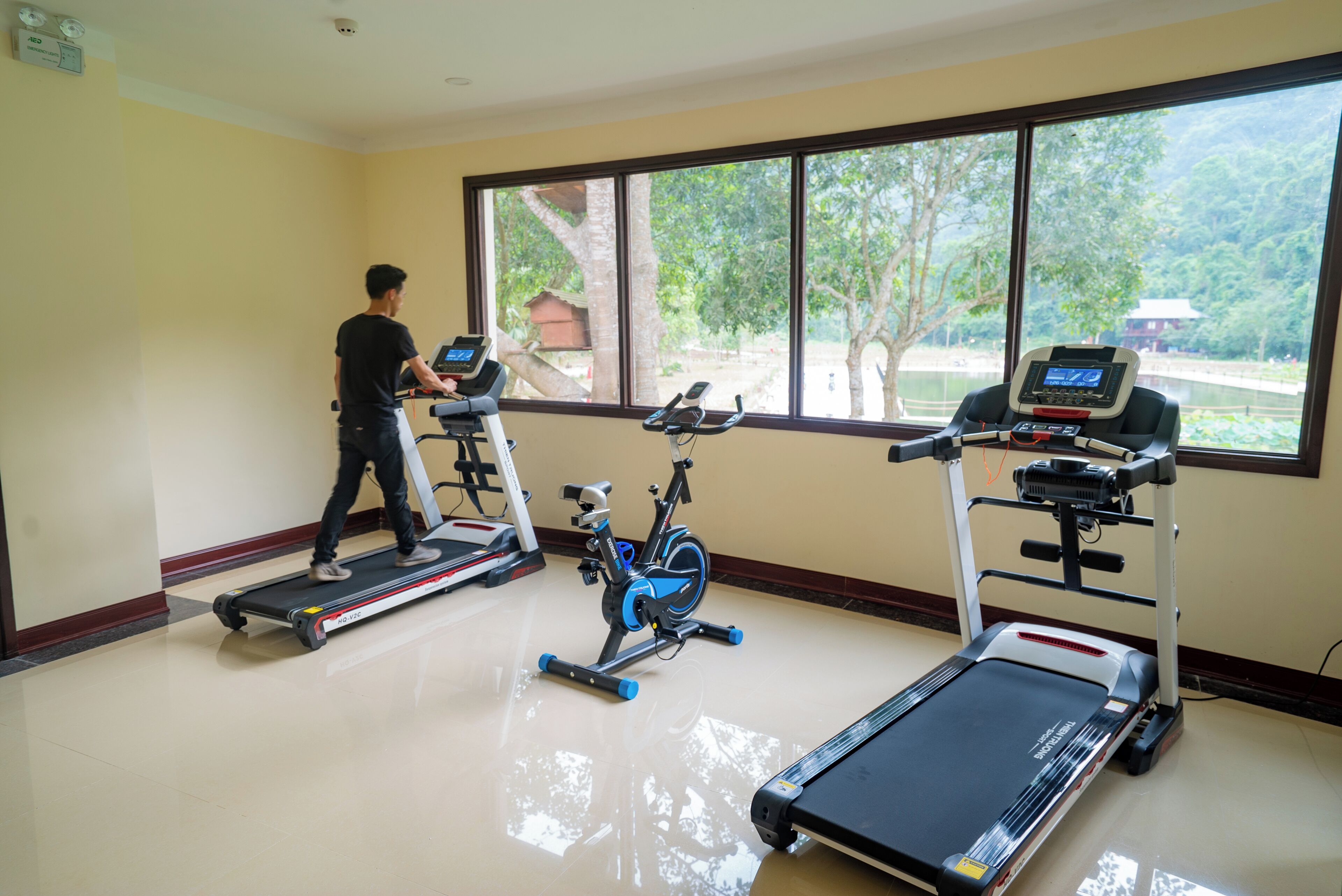 A gym with treadmills, an exercise bike, and a rowing machine.